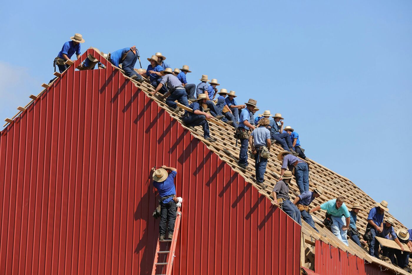 Construction crew working together on a roof