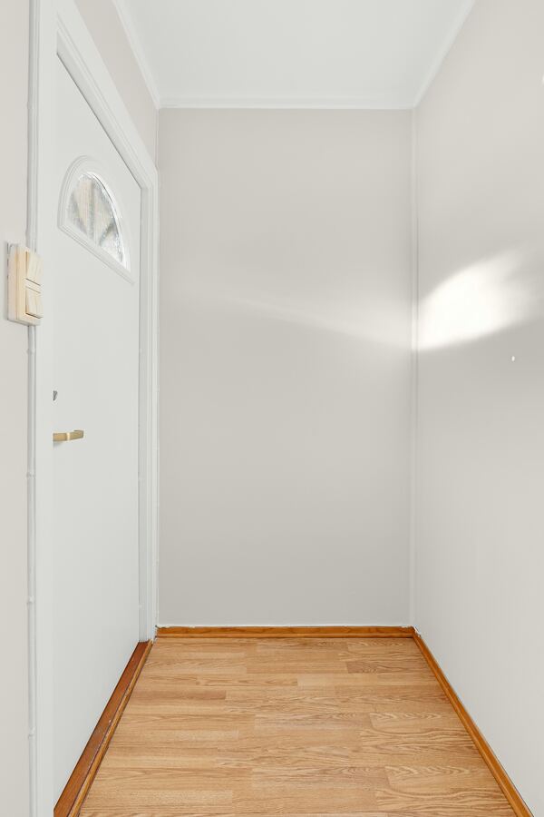 Empty room with finished hardwood flooring