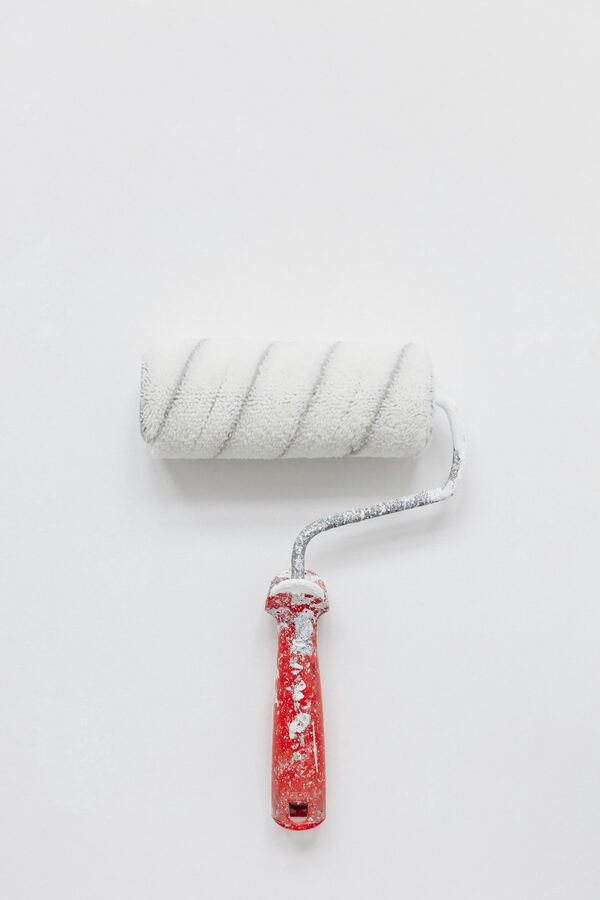 Paint roller with red handle ready for a fresh coat